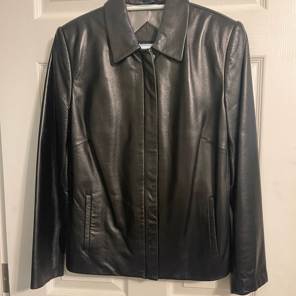 Women’s waist length black leather jacket.